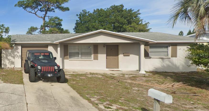 ranch-style home featuring a garage