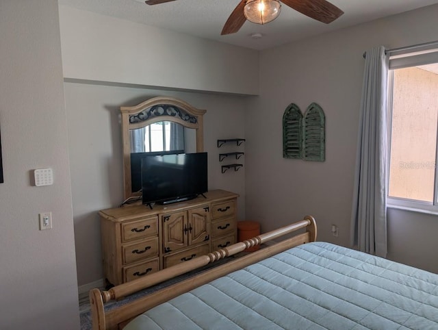 bedroom with multiple windows and ceiling fan