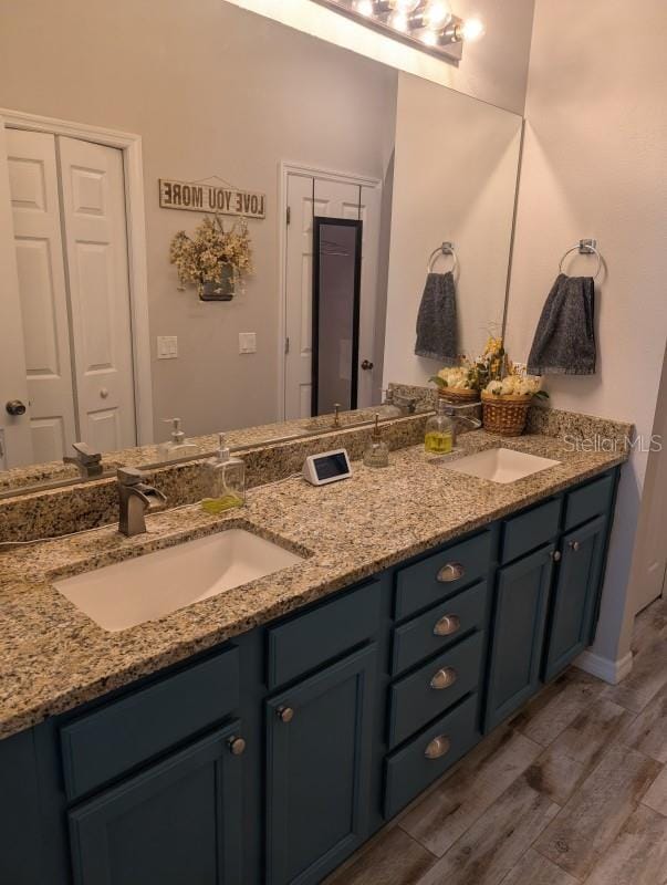 bathroom with vanity and hardwood / wood-style flooring