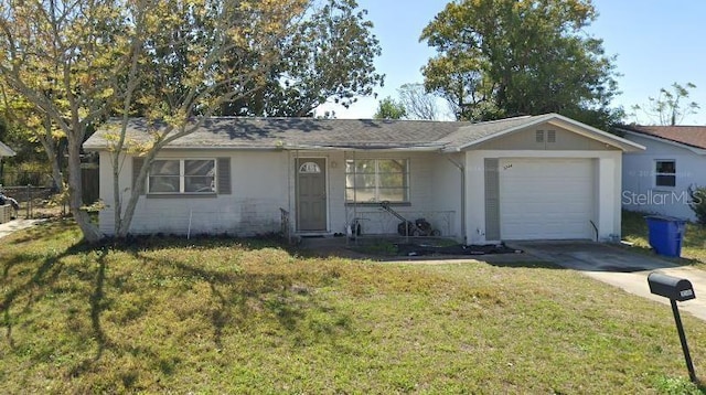 ranch-style house featuring a garage and a front lawn