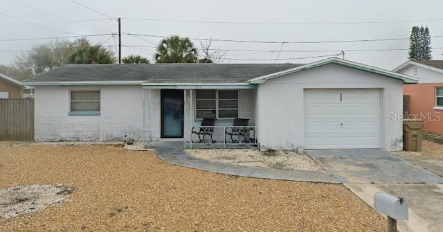 ranch-style home with a garage and a porch