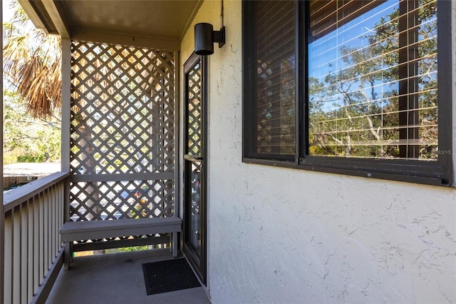 view of exterior entry featuring a balcony