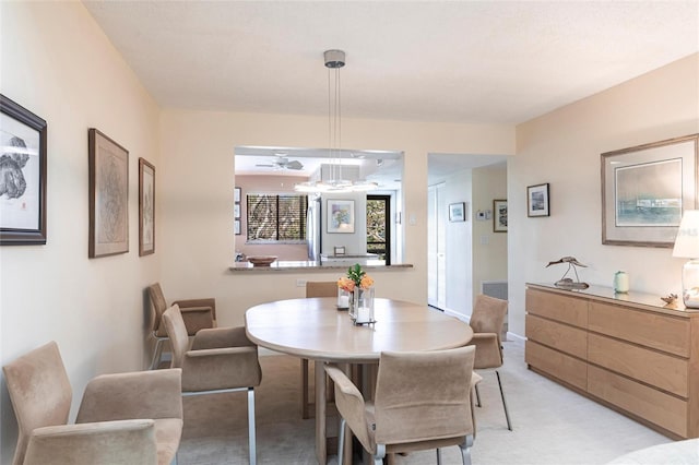 dining room featuring light carpet