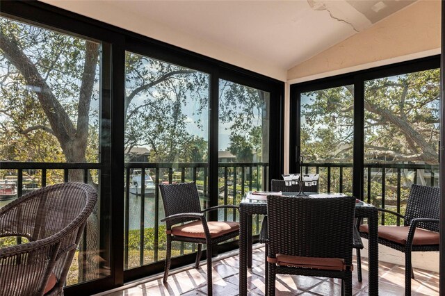 sunroom featuring lofted ceiling and plenty of natural light