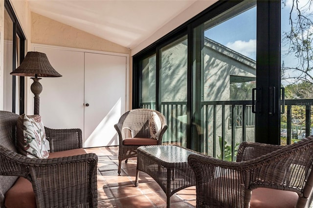 sunroom featuring lofted ceiling