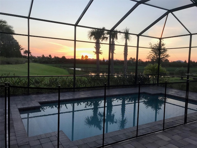 pool featuring a patio area and glass enclosure