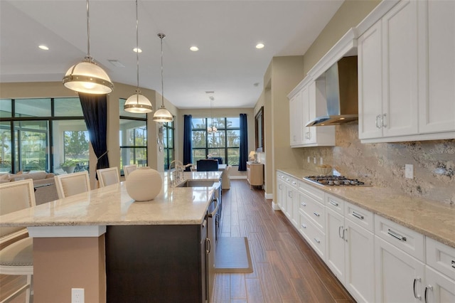 kitchen featuring a breakfast bar, pendant lighting, and a kitchen island with sink