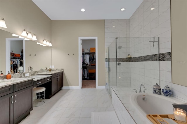 bathroom featuring a spacious closet, a stall shower, a garden tub, and vanity