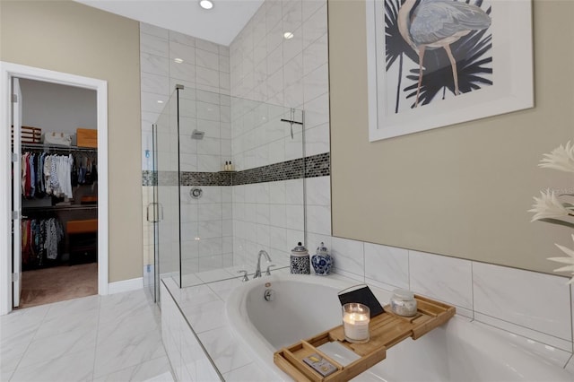 full bath with a garden tub, a shower stall, a spacious closet, and marble finish floor