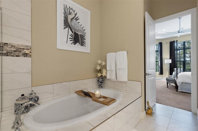 ensuite bathroom featuring a ceiling fan, tile patterned flooring, a garden tub, and ensuite bath