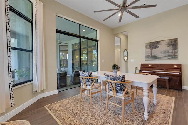 dining room featuring dark wood-style floors, baseboards, and a ceiling fan