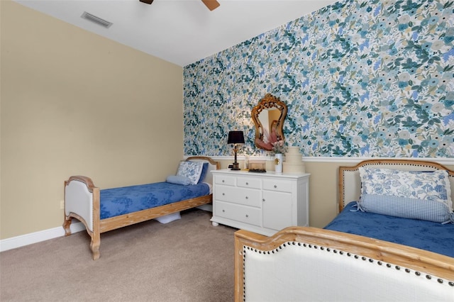 bedroom with carpet floors, visible vents, baseboards, and a ceiling fan