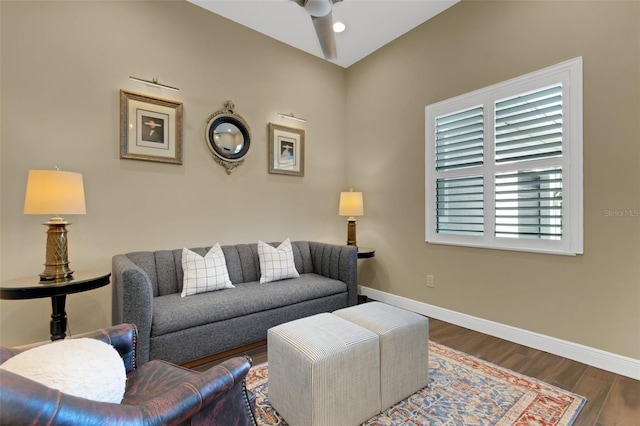 living room featuring dark wood-style floors, baseboards, and a ceiling fan