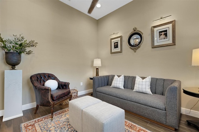 living area with dark wood-type flooring and baseboards