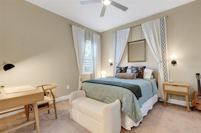 carpeted bedroom with a ceiling fan and baseboards