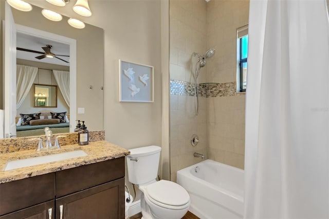 ensuite bathroom with toilet, ensuite bathroom, a ceiling fan, shower / tub combo, and vanity