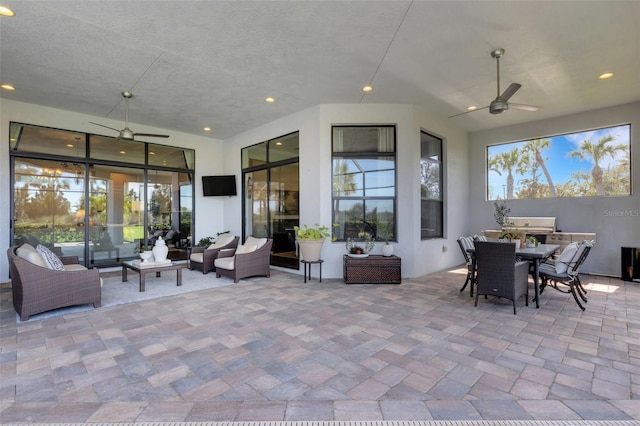 view of patio / terrace featuring outdoor dining area, ceiling fan, and an outdoor hangout area