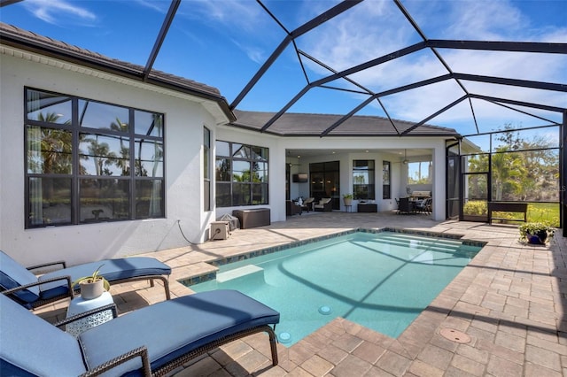 pool featuring a patio area and glass enclosure