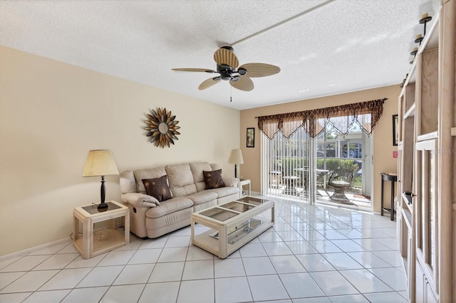 tiled living room featuring a textured ceiling and ceiling fan