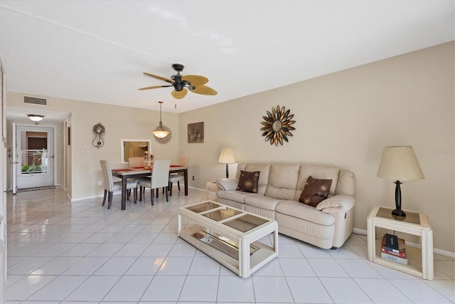 living room featuring light tile patterned flooring and ceiling fan