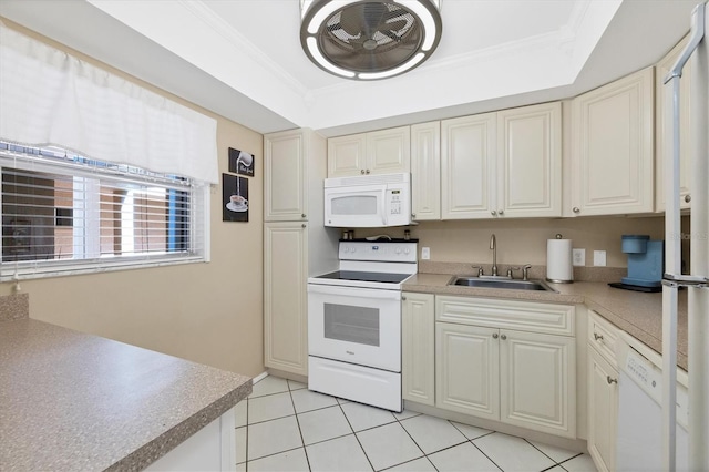 kitchen featuring light tile patterned flooring, sink, crown molding, a tray ceiling, and white appliances