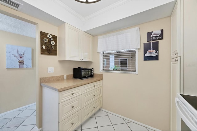 kitchen with crown molding and light tile patterned floors