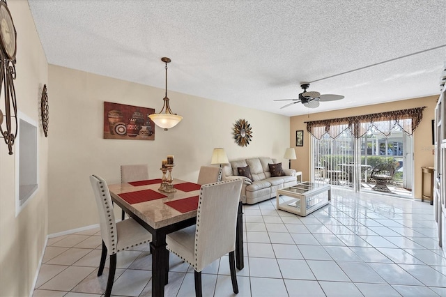 dining room with ceiling fan, light tile patterned floors, and a textured ceiling