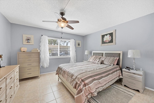 bedroom with light tile patterned flooring, a textured ceiling, and ceiling fan