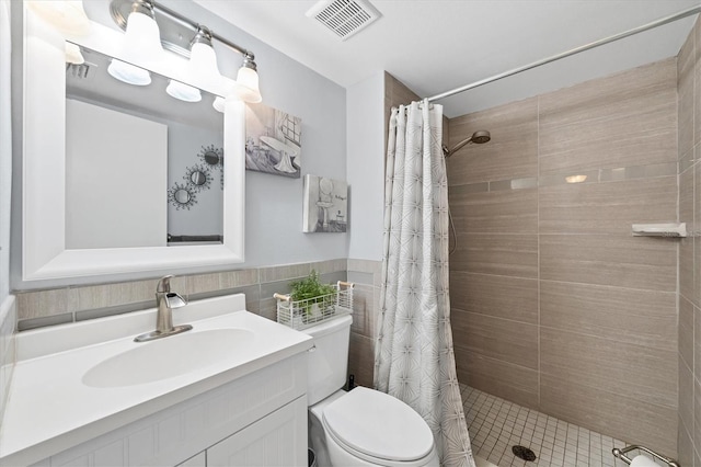 bathroom with vanity, toilet, a shower with shower curtain, and tile walls