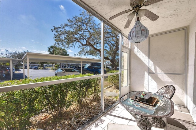 unfurnished sunroom featuring ceiling fan