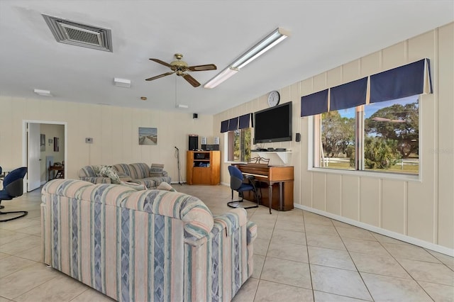 tiled living room with ceiling fan and a healthy amount of sunlight