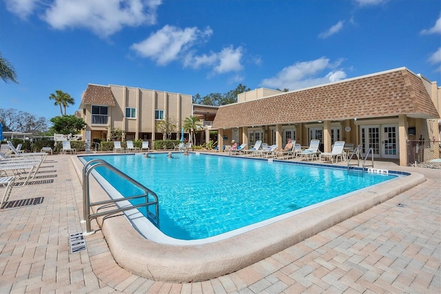 view of swimming pool with a patio area and french doors