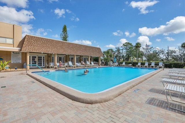 view of pool featuring french doors and a patio