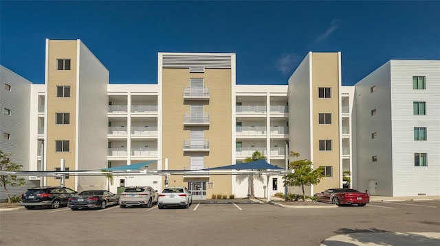 view of building exterior with uncovered parking