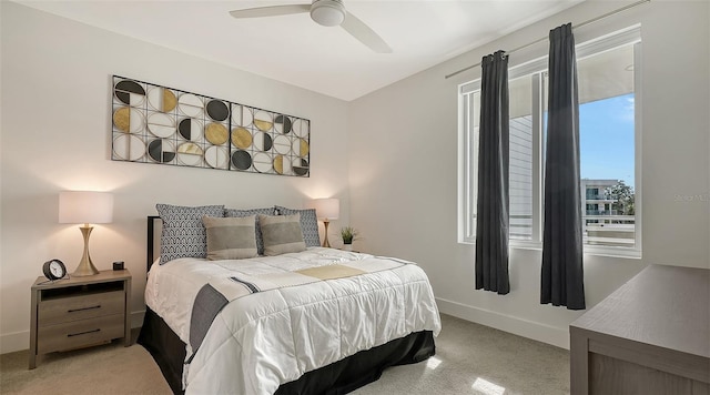 bedroom with light colored carpet, ceiling fan, and baseboards