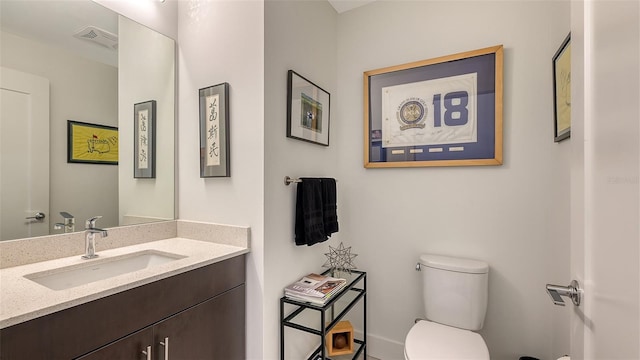 bathroom featuring visible vents, vanity, and toilet