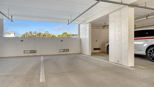 parking garage featuring concrete block wall