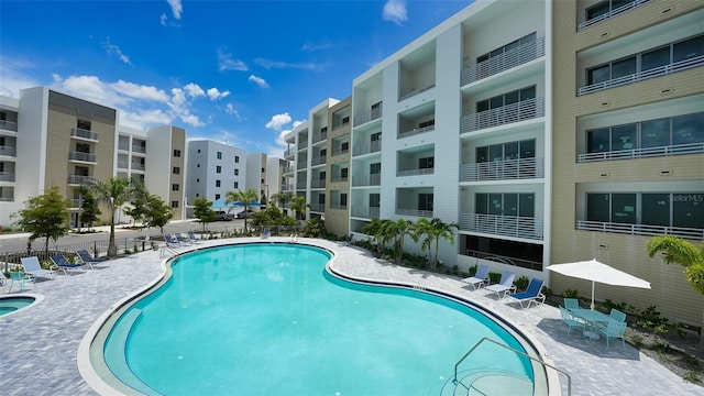 community pool with a patio area