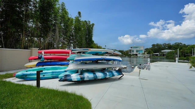 view of car parking featuring a water view