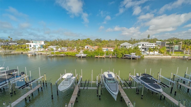 view of dock with a water view, boat lift, and a residential view