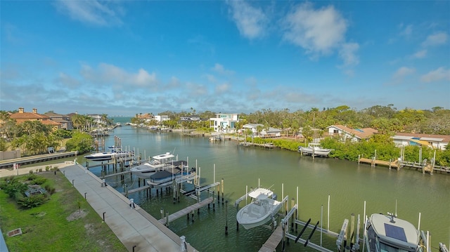 view of dock with a water view, boat lift, and a residential view