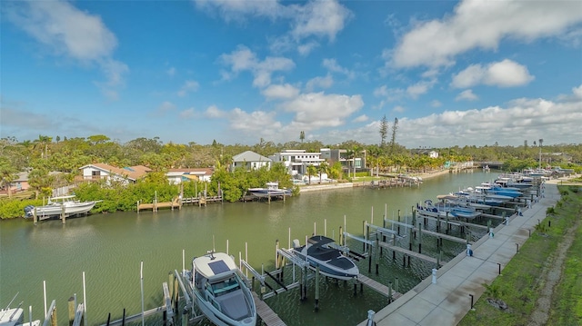 view of dock with a water view, boat lift, and a residential view