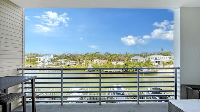 balcony featuring a water view and a residential view