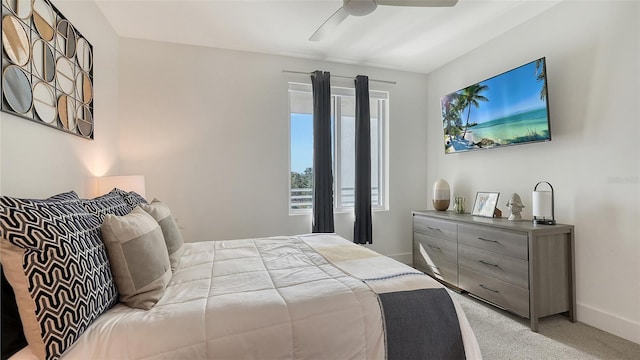 bedroom with light carpet, baseboards, and a ceiling fan