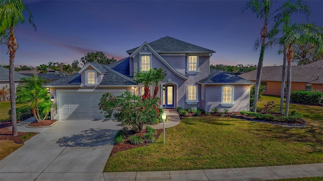 view of front facade featuring a garage and a lawn