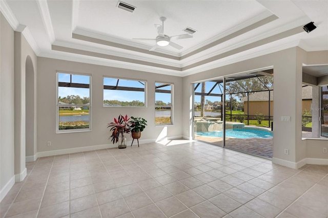 interior space featuring a water view, ceiling fan, and a raised ceiling