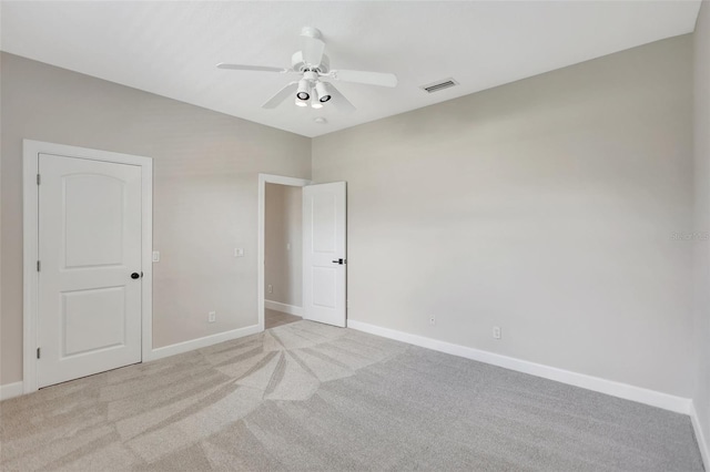 unfurnished bedroom featuring ceiling fan and light carpet