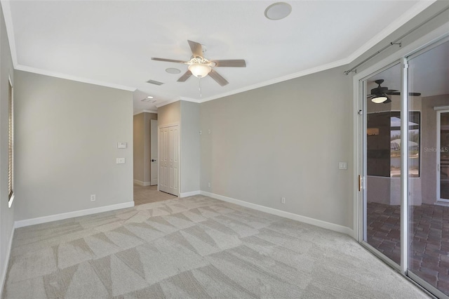 spare room featuring ornamental molding, light carpet, and ceiling fan