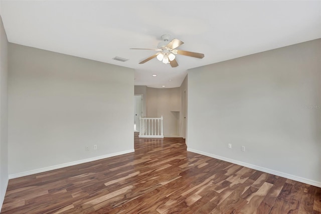 unfurnished room featuring dark hardwood / wood-style floors and ceiling fan