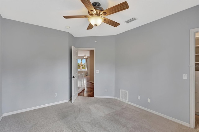 unfurnished room with ceiling fan and light colored carpet